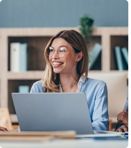 Consultant smiling while working on a laptop